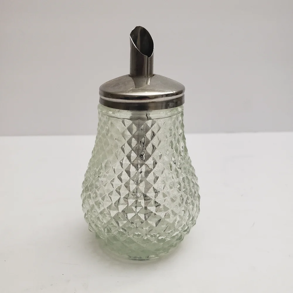 Glass sugar dispenser with a metal lid and spout. 206